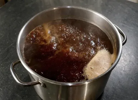 wort flowing from the lauter tun during runoff, showing the clarity and color brewers check alongside wort Plato readings
